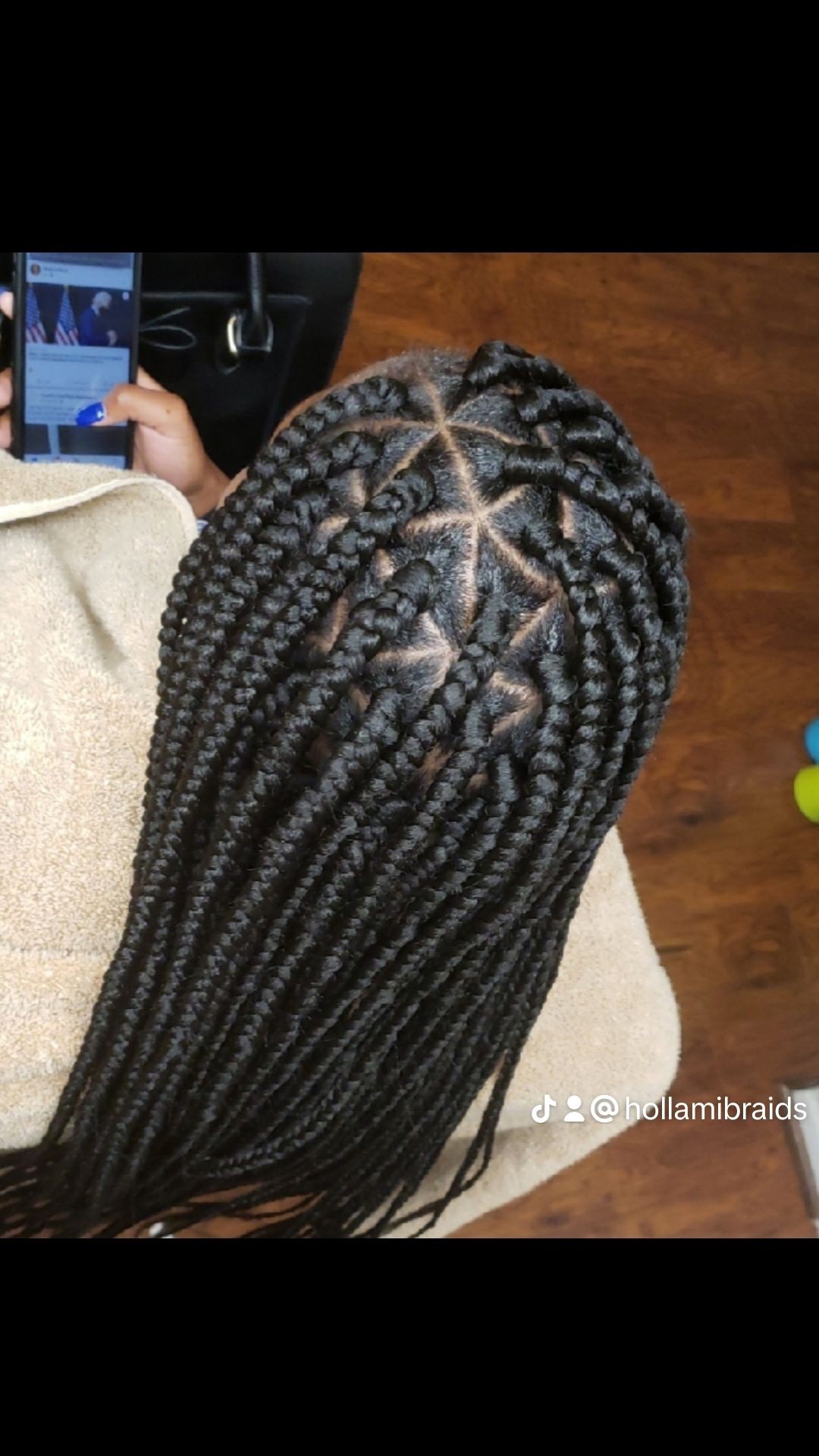 Top view of a person's head with intricately braided hair patterns.