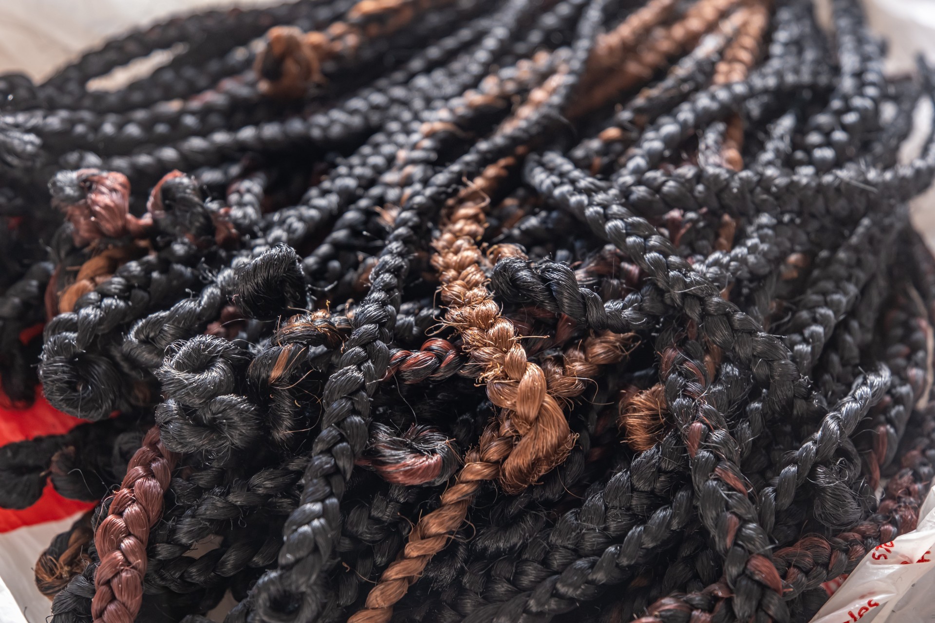 Pile of hair braids for braiding hair in a hair saloon